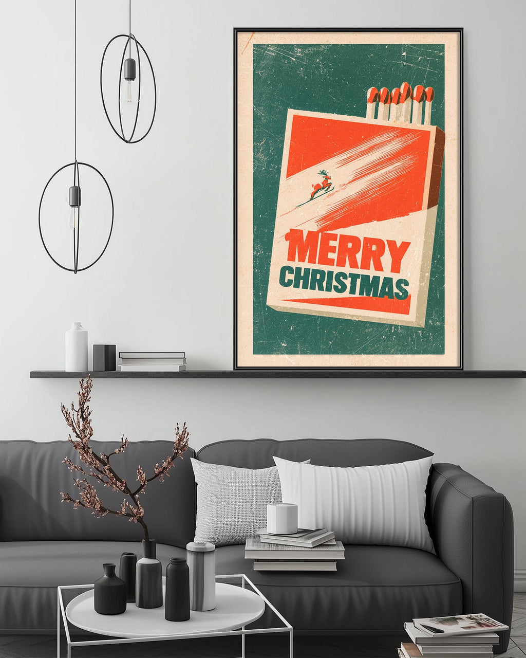 a cozy living room with a gray couch, a coffee table, and a large framed poster of a matchbox with a Christmas-themed design.
