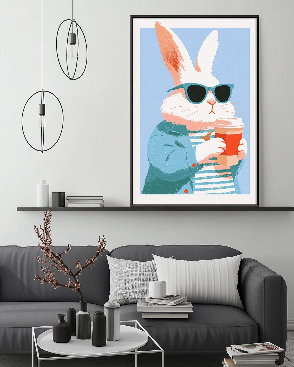 a cozy living room with a gray couch, a coffee table, and a large framed illustration of a rabbit wearing sunglasses and holding a coffee cup.