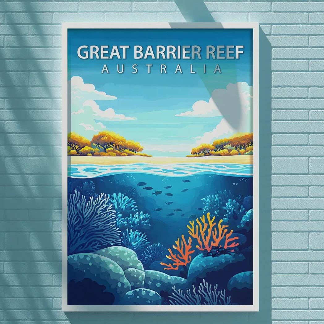 A framed poster of the Great Barrier Reef in Australia is displayed on a light blue brick wall.