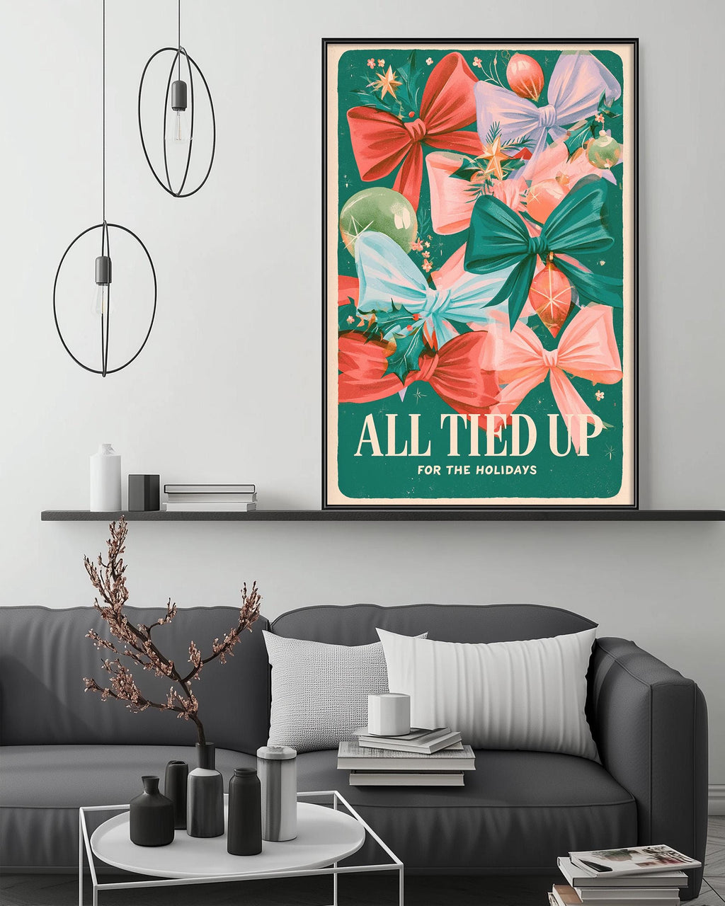 a living room with a gray couch, a coffee table, and a framed poster with a colorful design of bows and flowers hanging on the wall above the couch.