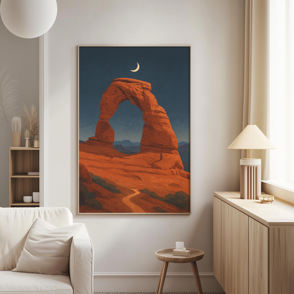 a large framed painting of a desert landscape with a crescent moon in the sky, hanging on a wall in a living room.