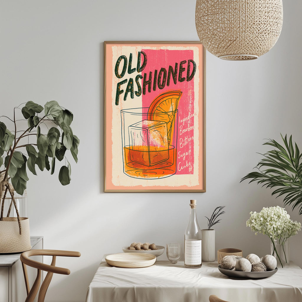 a framed poster of a cocktail glass with an orange slice, hanging on a wall above a dining table with various items on it.