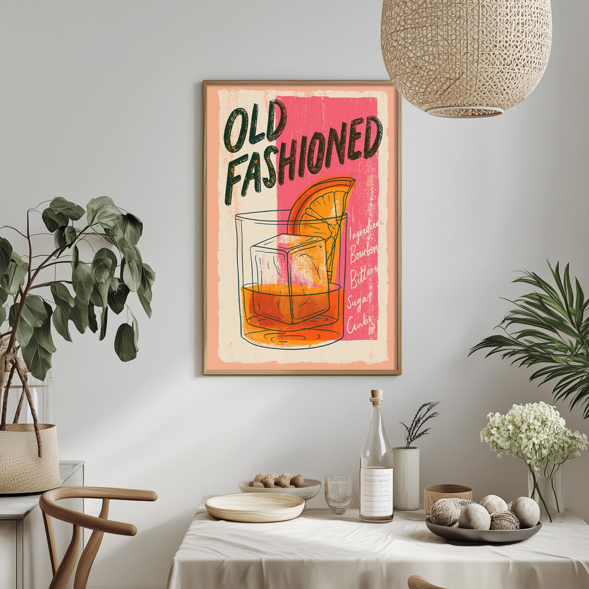 a framed poster of a cocktail glass with an orange slice, hanging on a wall above a dining table with various items on it.