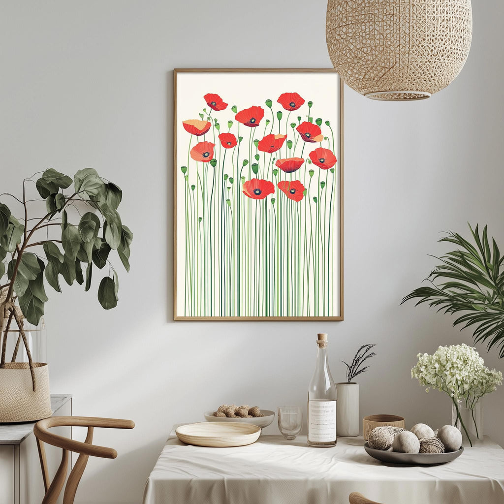 a dining table with a white tablecloth, a bowl of fruit, a bottle, and a vase with flowers. Above the table, there is a framed picture of red poppies with green stems.