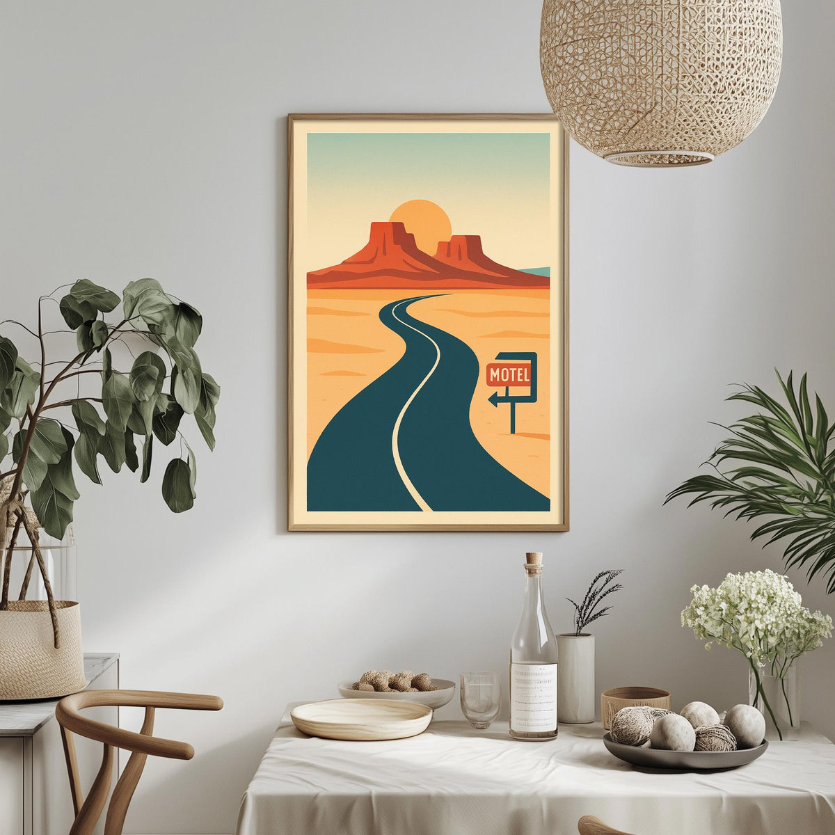 a framed poster of a desert road with a motel sign, surrounded by a dining table, chairs, and potted plants.