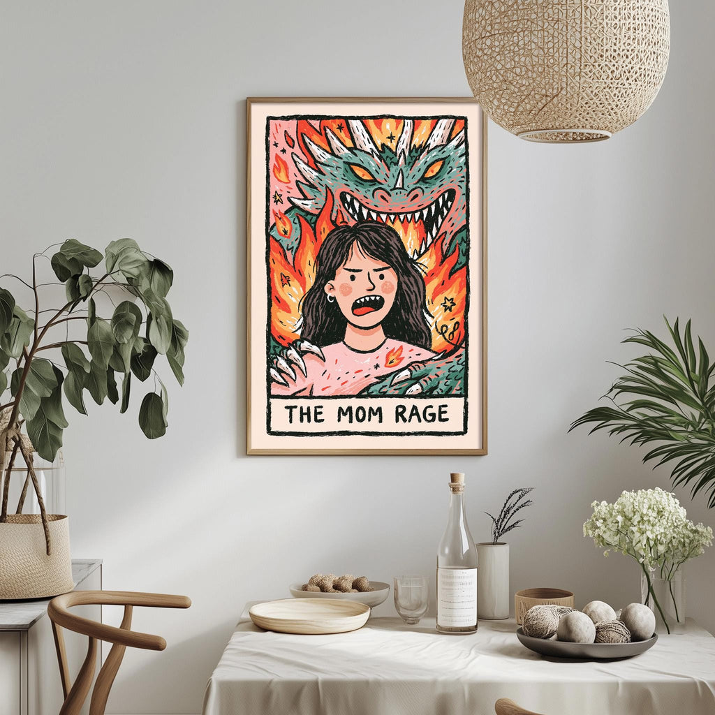 a framed illustration of a woman with a dragon-like creature behind her, and the text "THE MOM RAGE" below the illustration.
