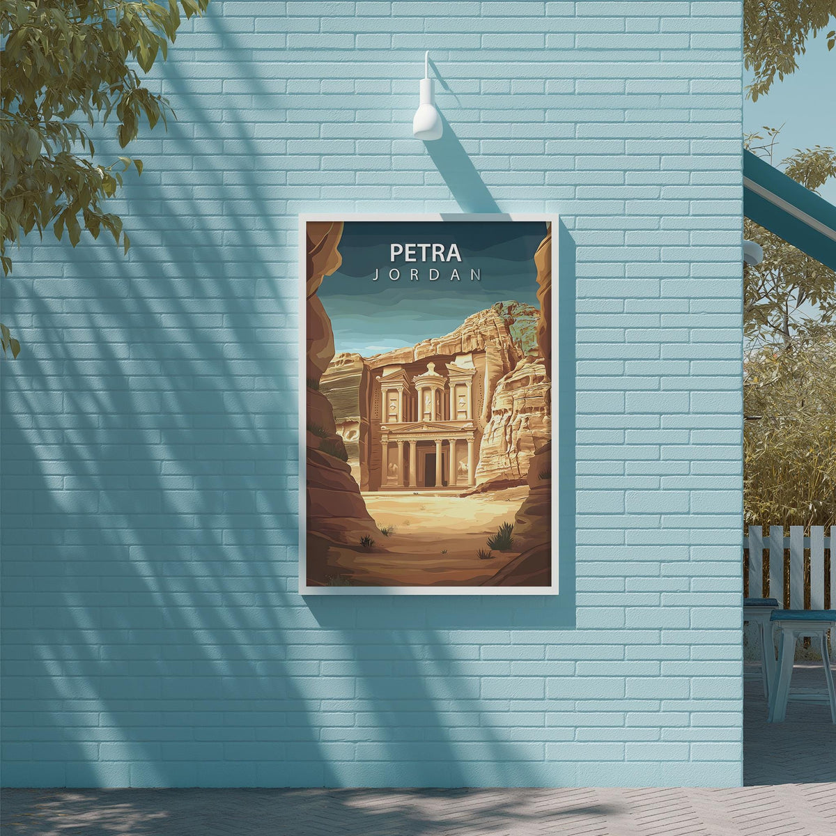 A framed poster of the Petra, a famous ancient archaeological site in Jordan, is displayed on a light blue wall.