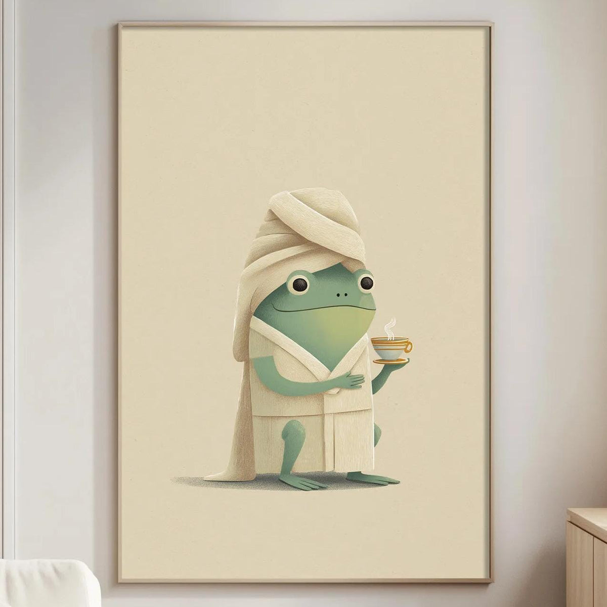 a cozy living room with a white sofa, a wooden side table, and a framed illustration of a frog wearing a bathrobe and holding a cup of tea.