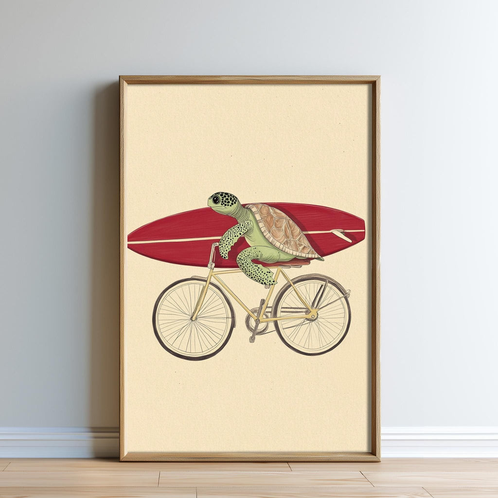 A framed illustration depicting a green sea turtle riding a bicycle with a red surfboard.