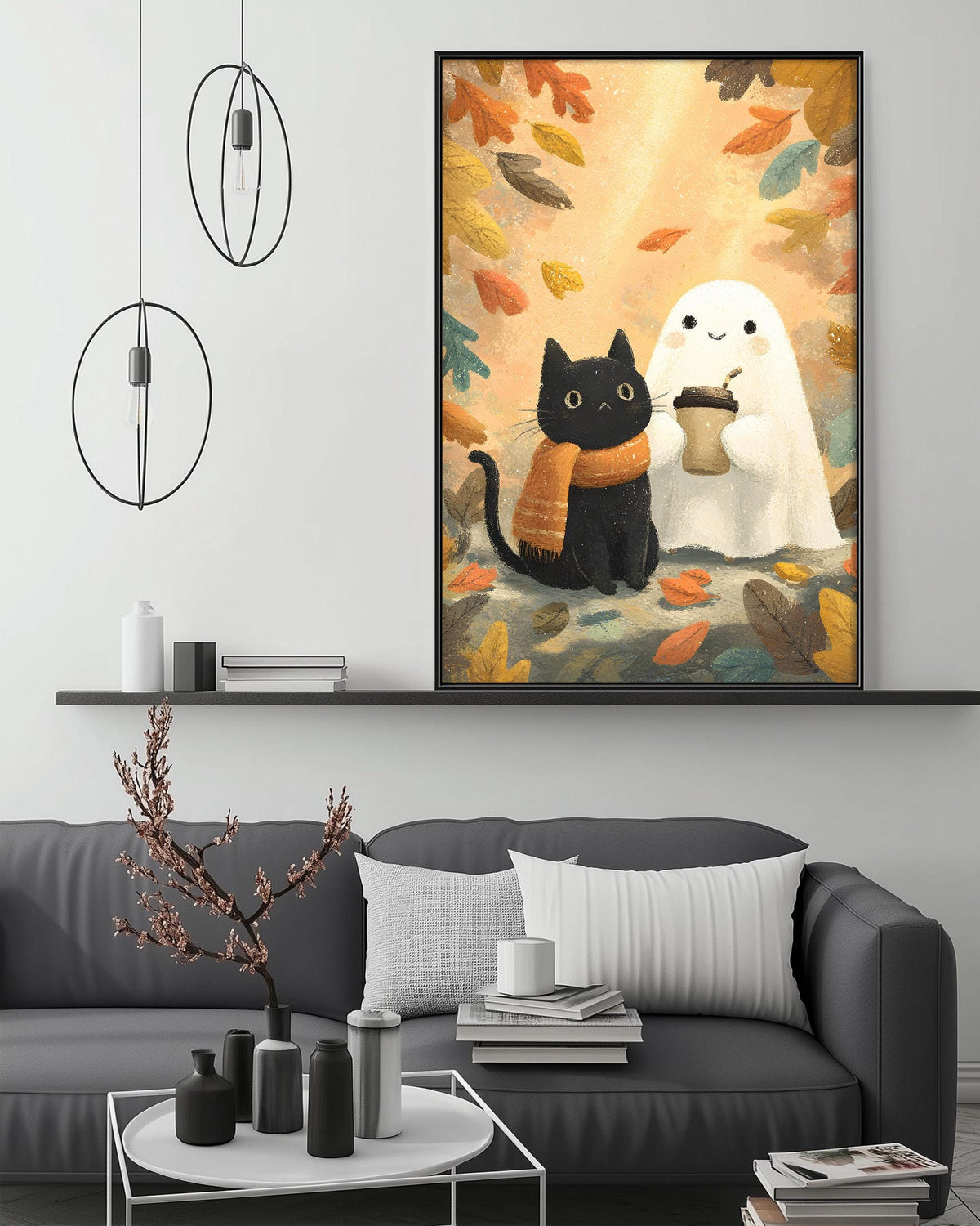 a cozy living room with a gray couch, a coffee table, and a framed artwork depicting a black cat and a ghost in a fall scene.