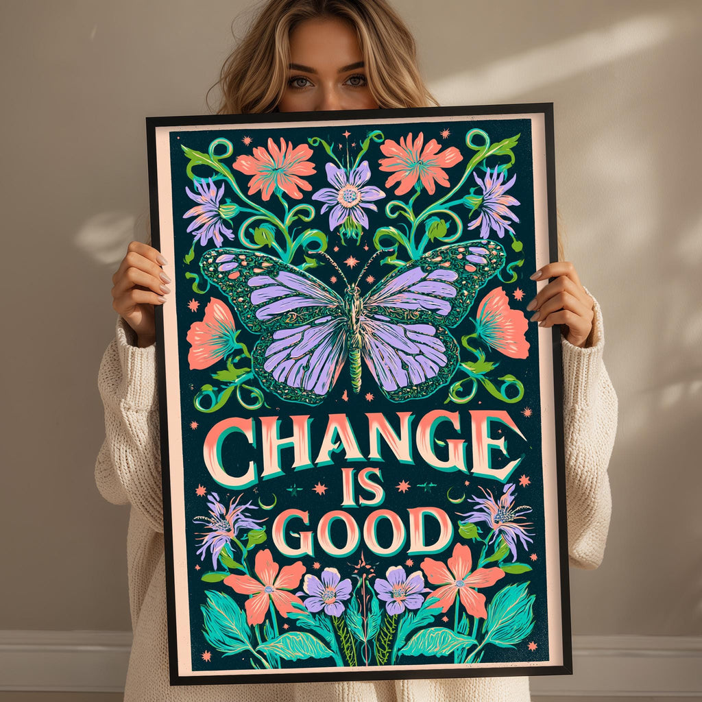 A woman holding a framed poster with a butterfly and floral designs, with the text "CHANGE IS GOOD" prominently displayed.