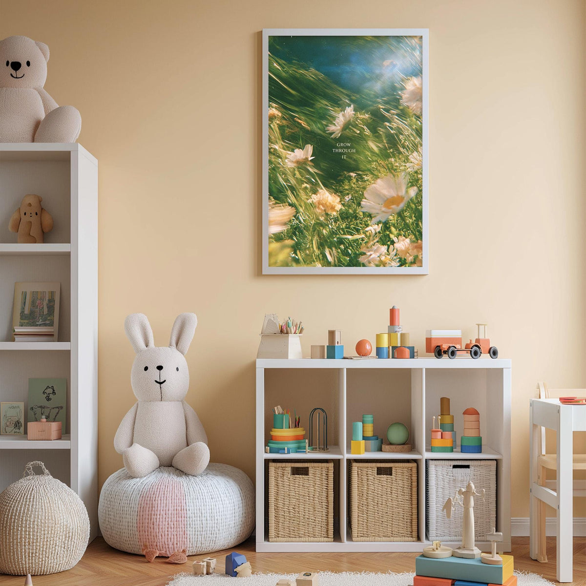 A cozy children's room with a white bookshelf, a plush rabbit, and a colorful toy box filled with toys. The walls are painted a light peach color, and a framed picture of flowers hangs above the bookshelf.