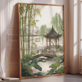 A framed painting depicting a serene garden scene with a traditional Chinese pavilion, bamboo trees, and a pond with lotus flowers.