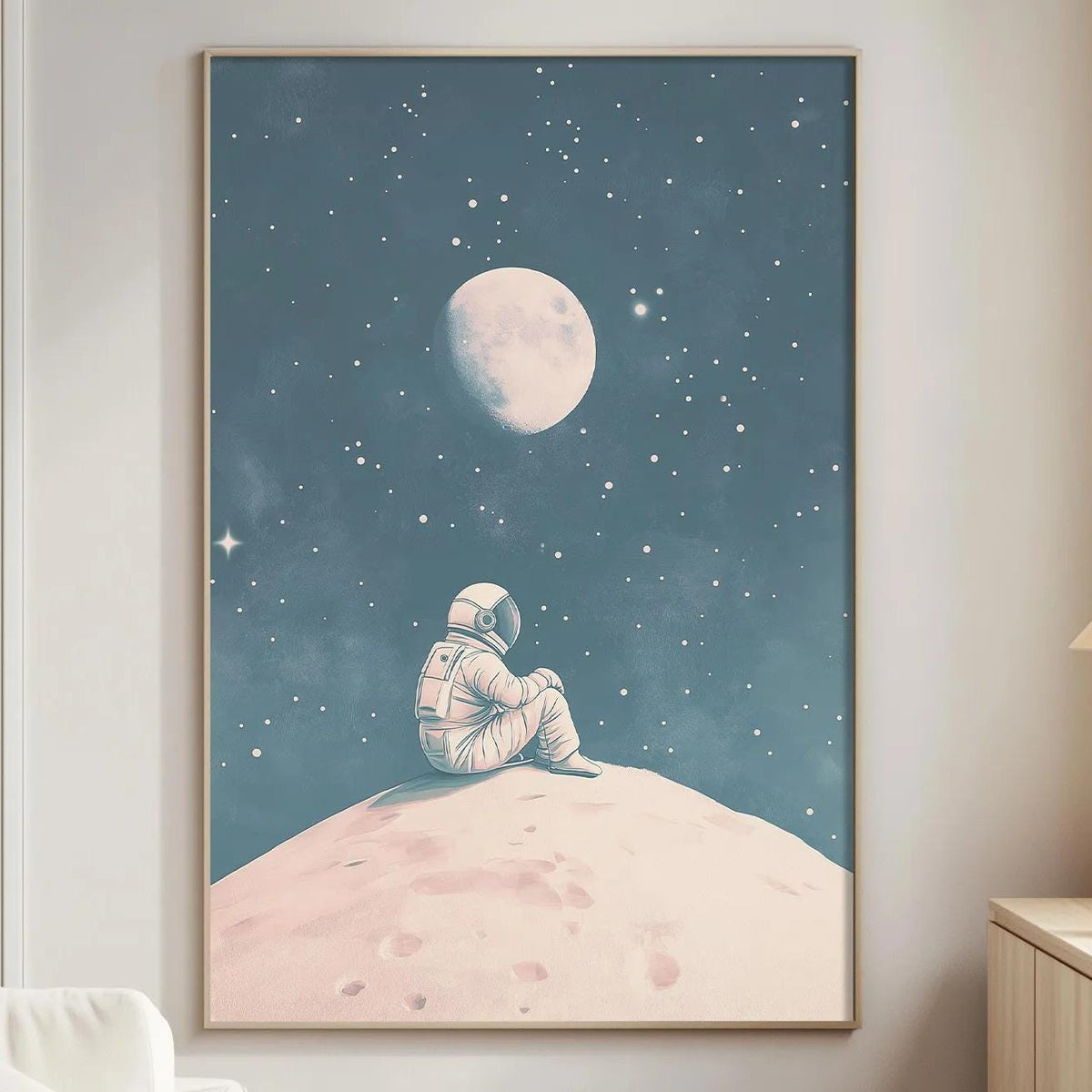 a cozy living room with a large framed poster of an astronaut sitting on a rocky surface, gazing up at the night sky with a full moon and stars.