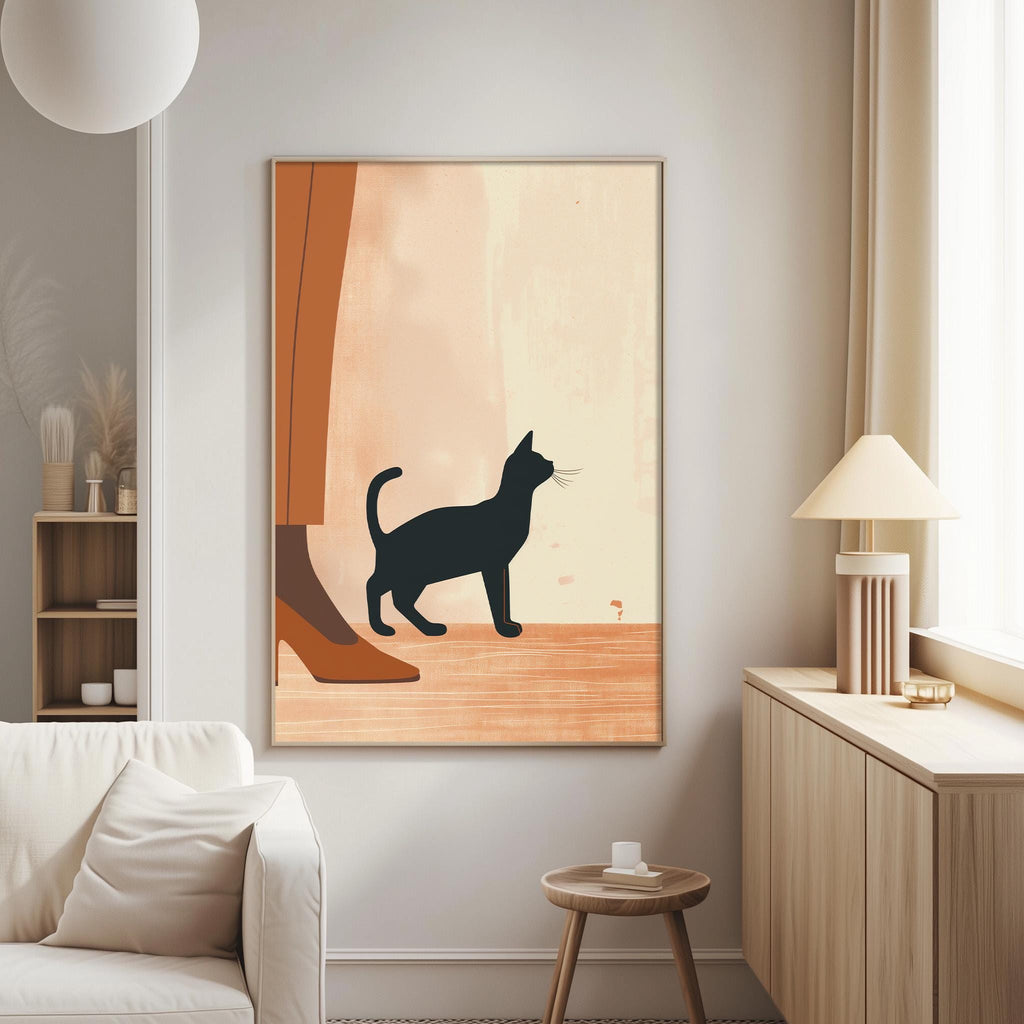 a living room with a white sofa, a wooden side table, and a framed artwork of a black cat on the wall.