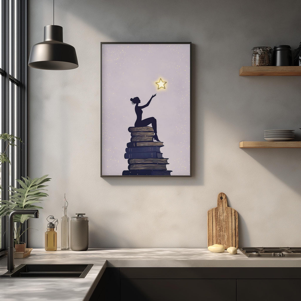 a framed illustration of a woman sitting on a stack of books, with a star above her, on a wall in a kitchen setting.