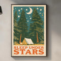 a framed poster with a camping scene and the text "SLEEP UNDER STARS" hanging on a wall above a kitchen counter.