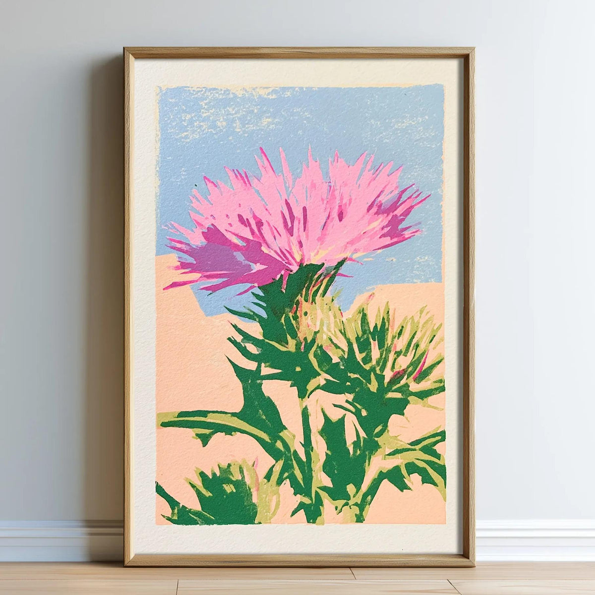 A framed print depicting a vibrant pink flower with green leaves against a blue sky background.