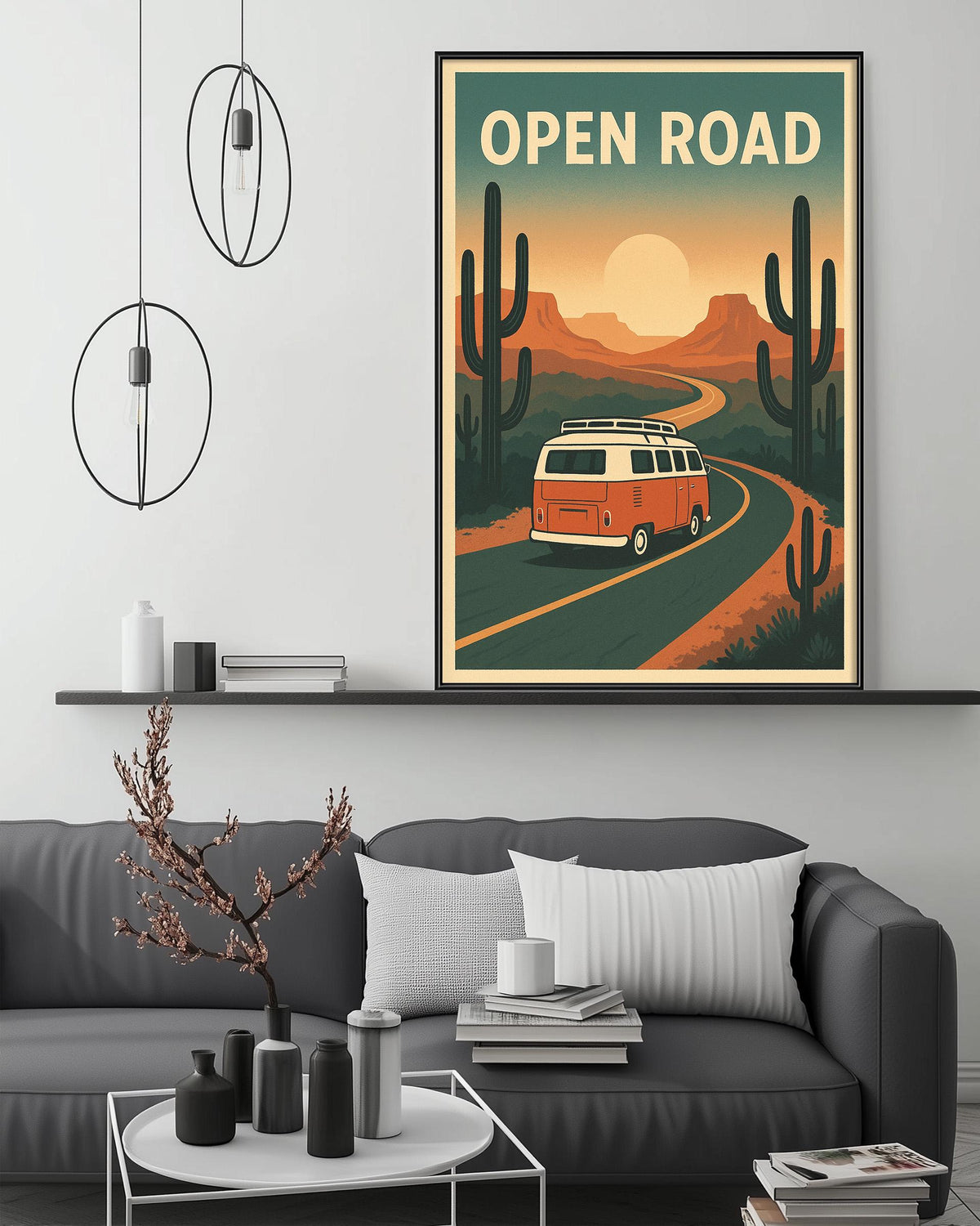 a cozy living room with a gray sofa, a coffee table, and a framed poster of a van driving on a road through a desert landscape.