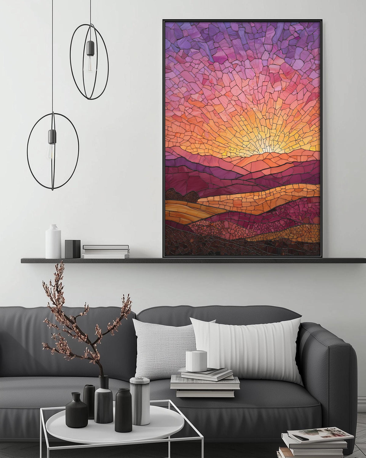 a modern living room with a gray sofa, a coffee table, and a large framed stained glass artwork depicting a sunset landscape.