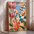 a large, colorful painting of flowers, including pink tulips and orange poppies, displayed on a wall in a room with a window.