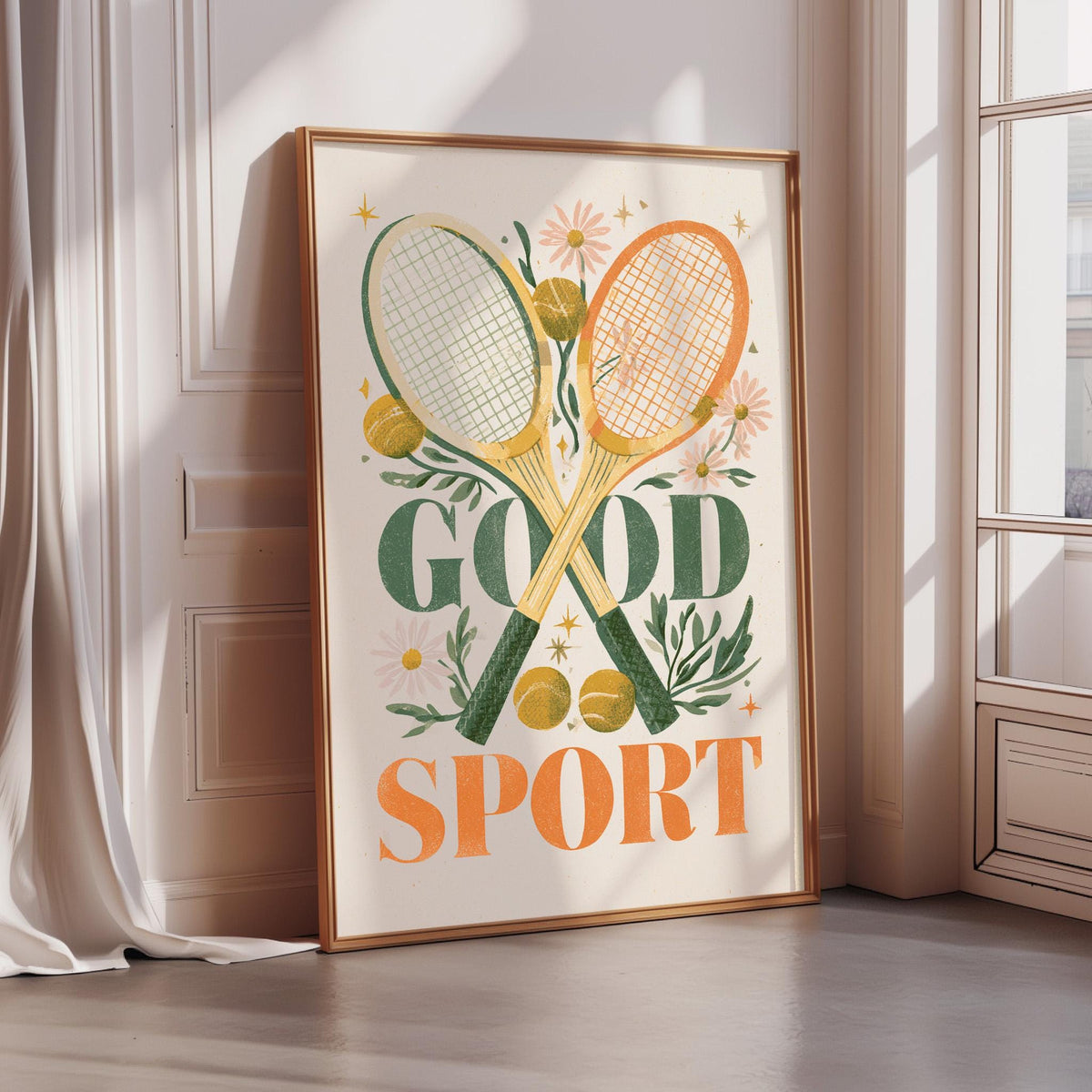 a framed poster with a tennis racket and flowers, along with the text "GOOD SPORT" prominently displayed.