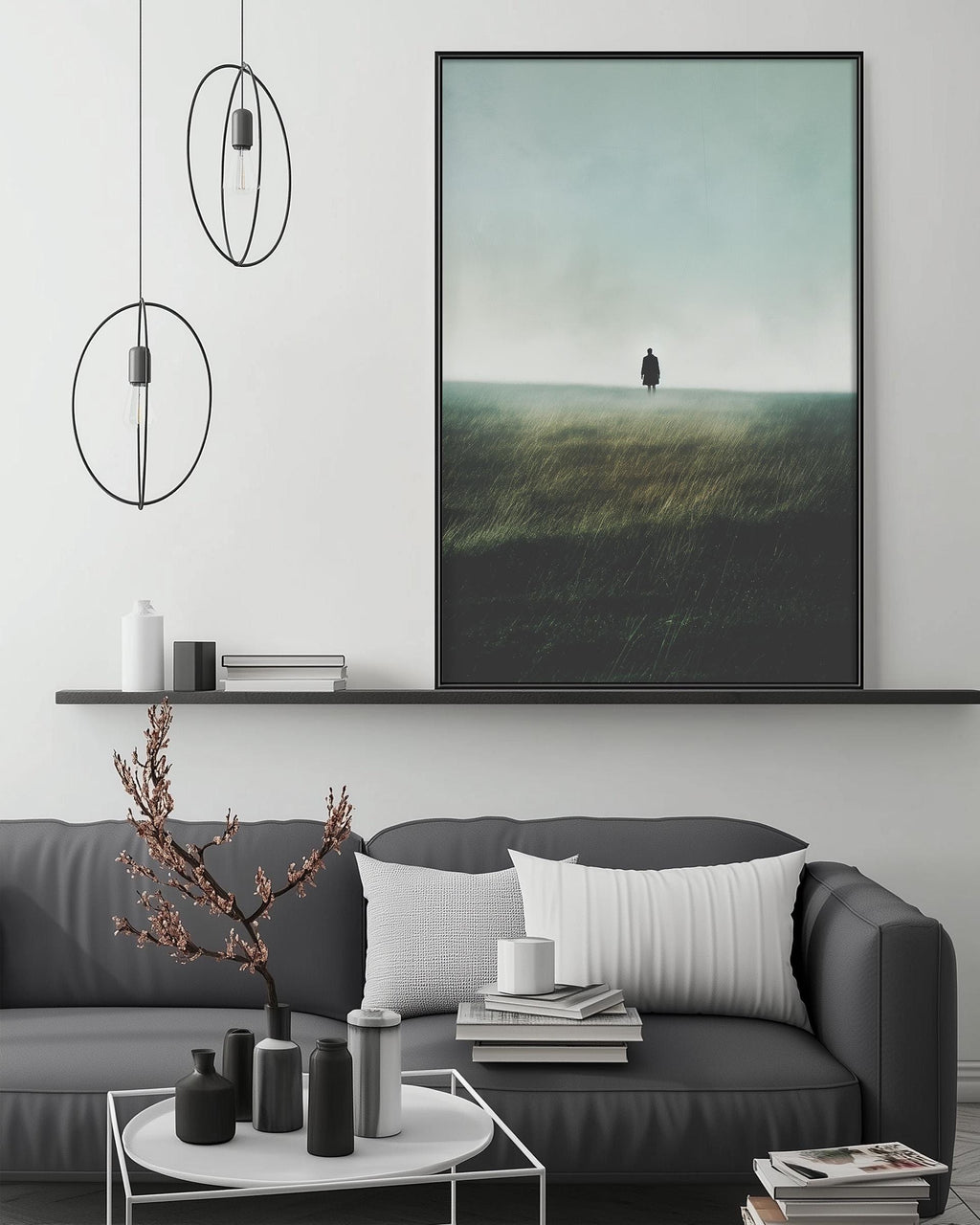 a modern living room with a gray sofa, a coffee table, and a large framed landscape painting depicting a person standing in a field.