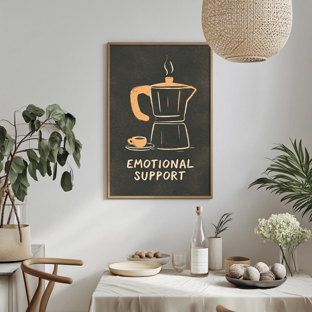 a framed poster with an illustration of a coffee maker and a cup, accompanied by the text "Emotional Support" on a wall. The poster is surrounded by various decorative elements, such as potted plants, vases, and a dining table with a bowl of fruit.