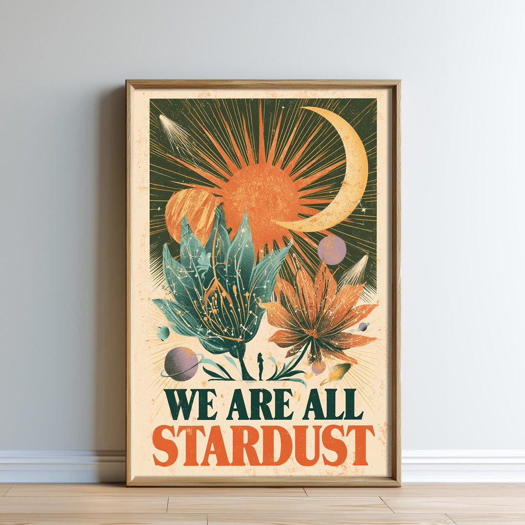 The image is a framed poster with a vibrant, colorful design featuring a crescent moon, sun, flowers, and various celestial elements. The text "WE ARE ALL STARDUST" is prominently displayed in the center of the poster.