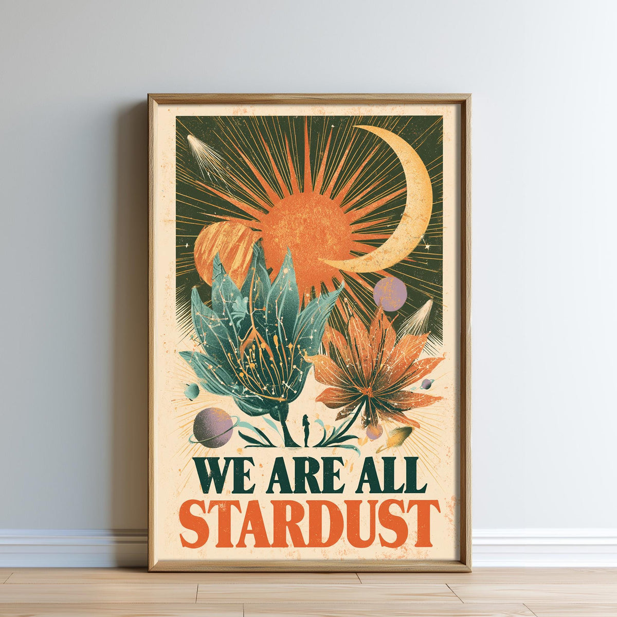 The image is a framed poster with a vibrant, colorful design featuring a crescent moon, sun, flowers, and various celestial elements. The text "WE ARE ALL STARDUST" is prominently displayed in the center of the poster.