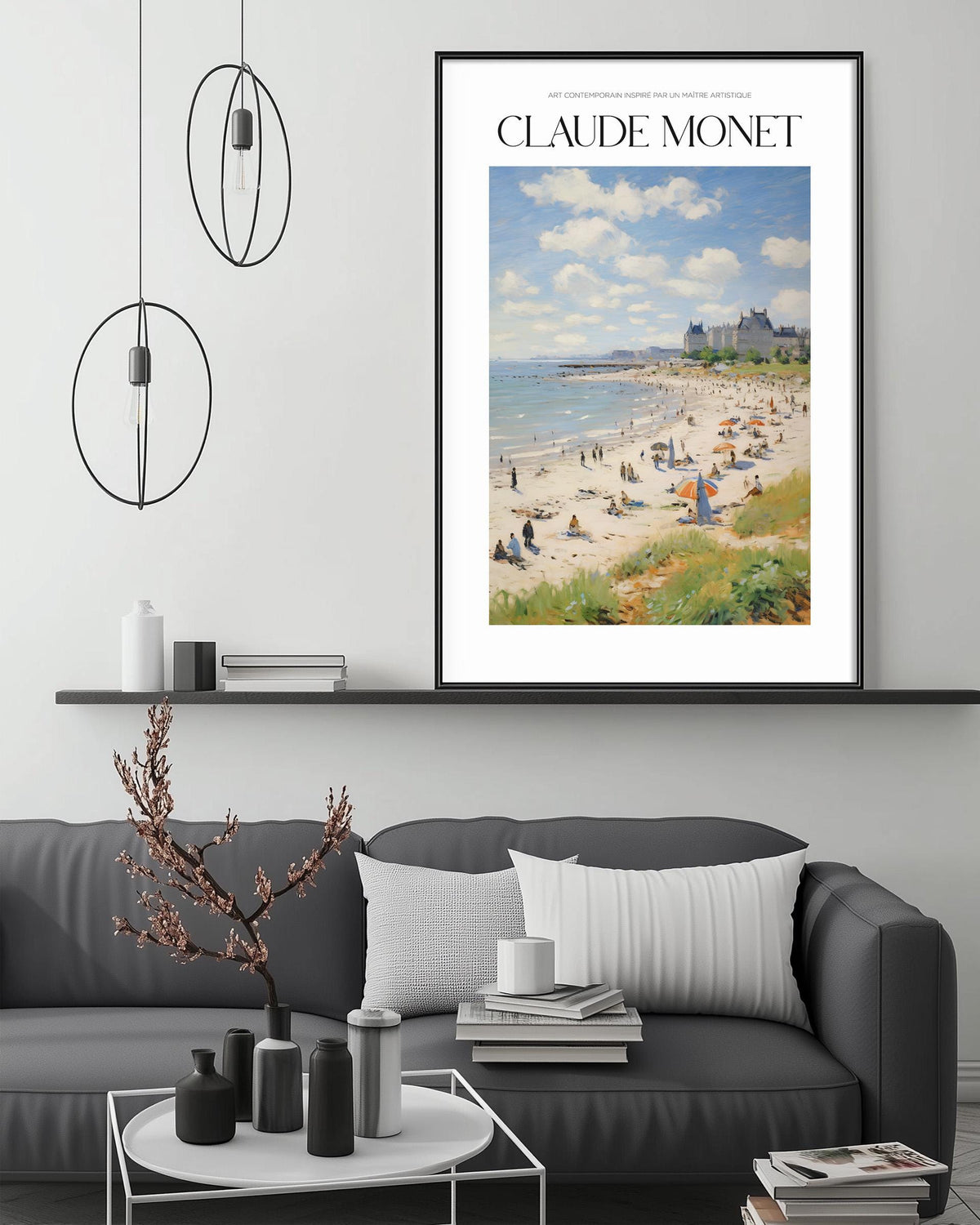 a framed painting of a beach scene with people and buildings in the background, hanging on a wall above a gray couch with decorative items on it.