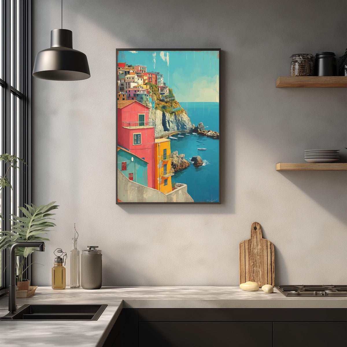 a kitchen with a framed painting of a colorful coastal town hanging on the wall above a countertop.
