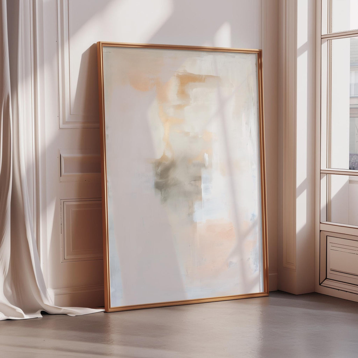 a large, abstract painting with a white background and a warm, orange and yellow color palette. The painting is displayed on a wall, leaning against a window, and is framed in a gold frame.