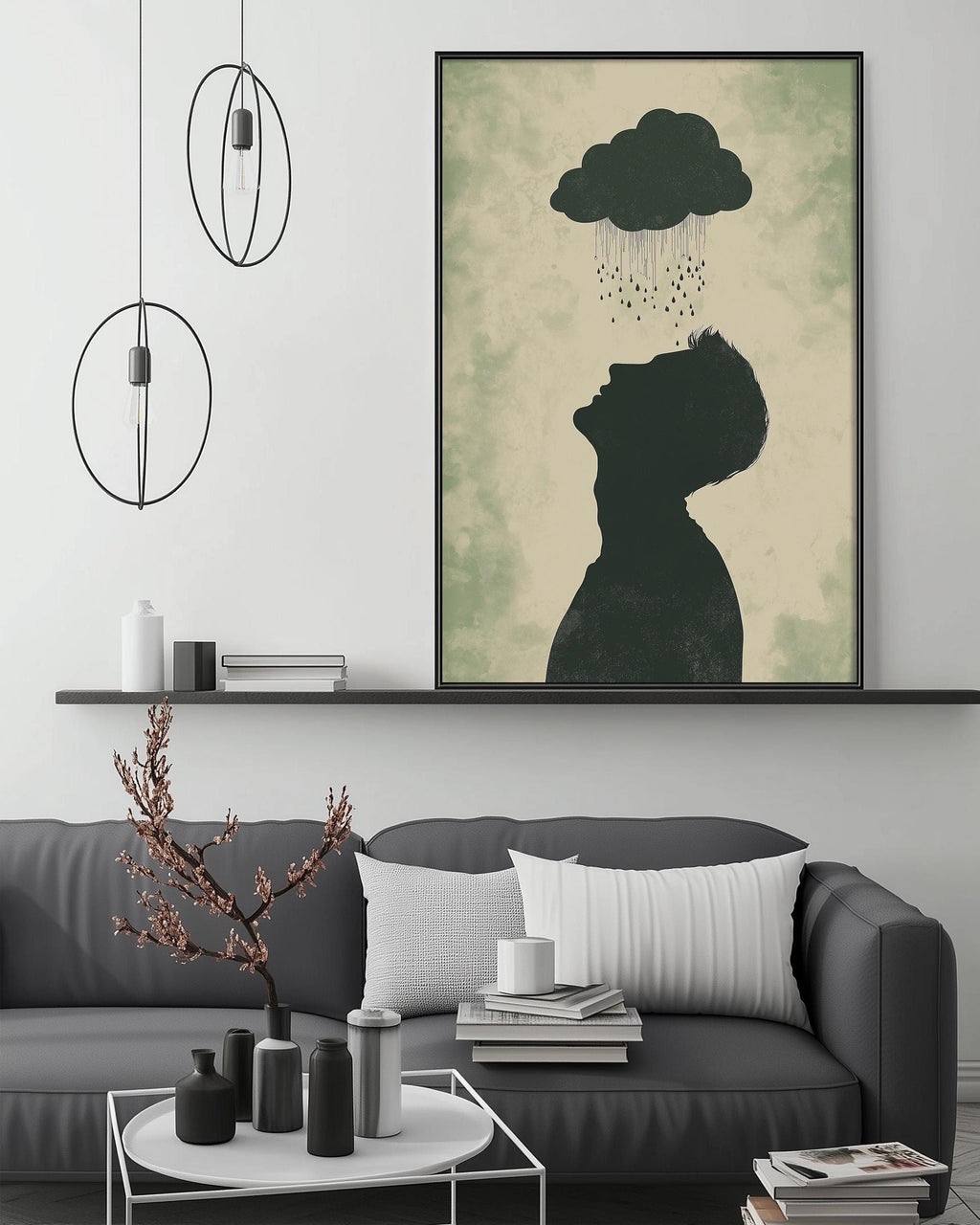 a living room with a gray sofa, a coffee table, and a large framed artwork depicting a silhouette of a person with a cloud above them. The artwork is hanging on the wall above the sofa.