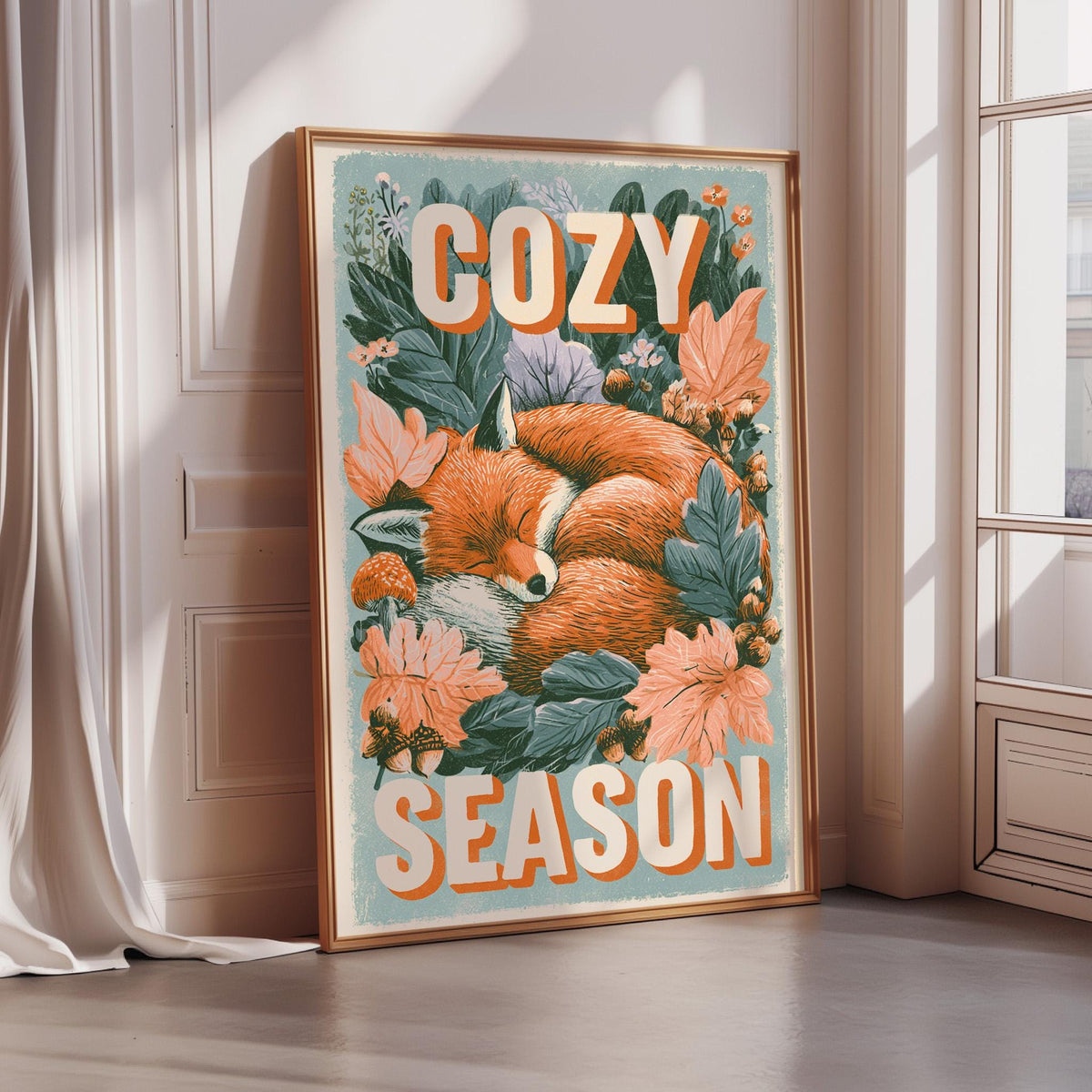 A framed poster with a sleeping fox surrounded by flowers and leaves, with the text "COZY SEASON" displayed prominently.