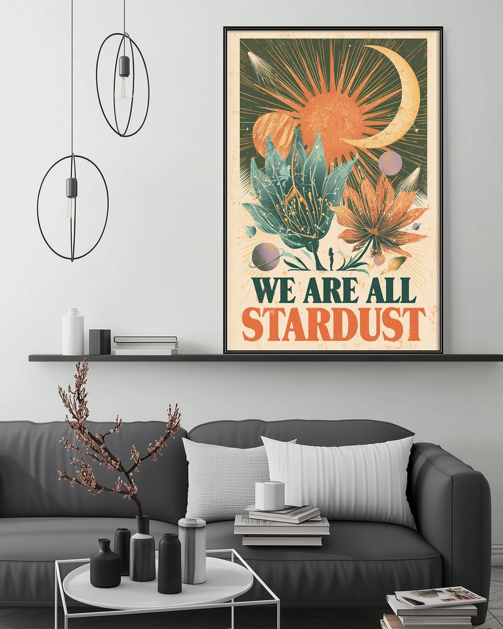 a living room with a gray couch, a coffee table, and a large framed poster hanging on the wall above the couch. The poster has a colorful, artistic design with a crescent moon, sun, and various plants and flowers.