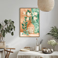 a dining table with a white tablecloth, a vase of flowers, and a bottle of wine. The table is set with plates, bowls, and other tableware. A framed painting of flowers is hanging on the wall above the table.
