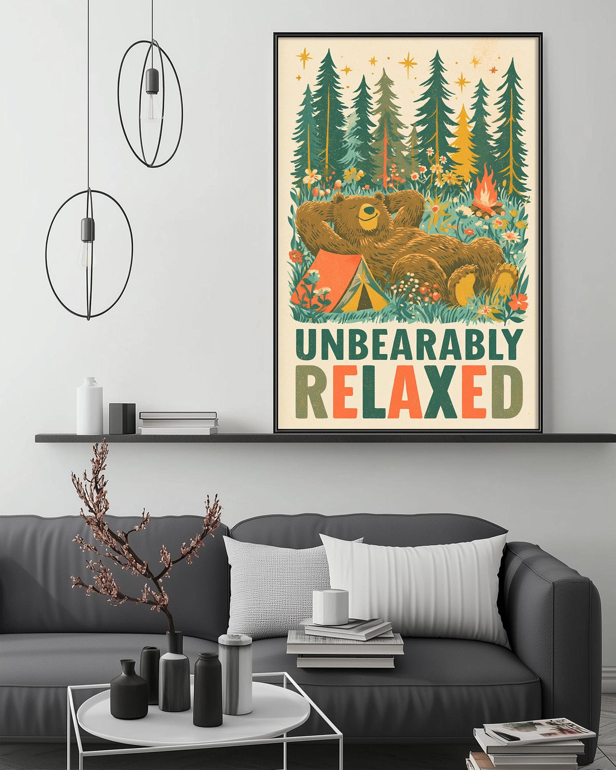 a cozy living room with a large framed poster of a bear resting in a forest setting, hanging on the wall above a gray couch.