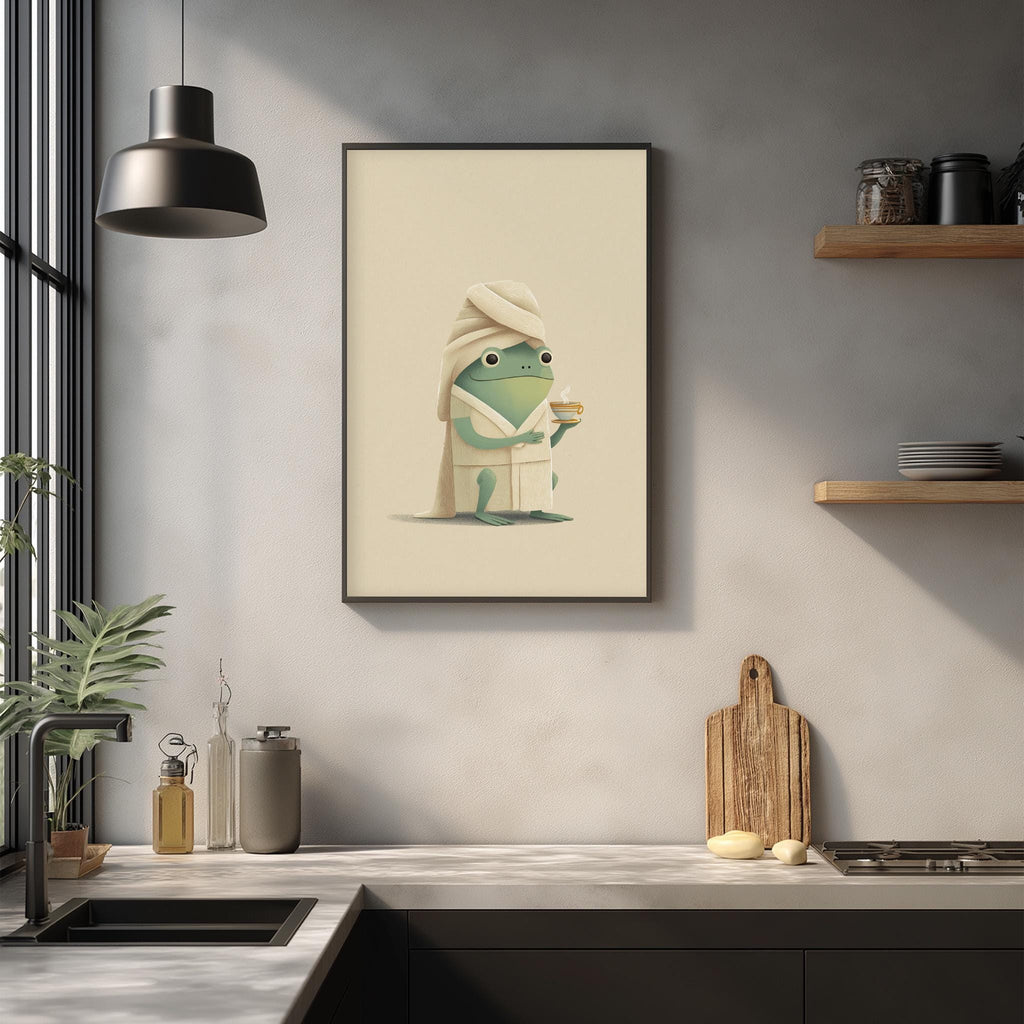a framed illustration of a frog wearing a towel, sitting on a counter in a kitchen setting.