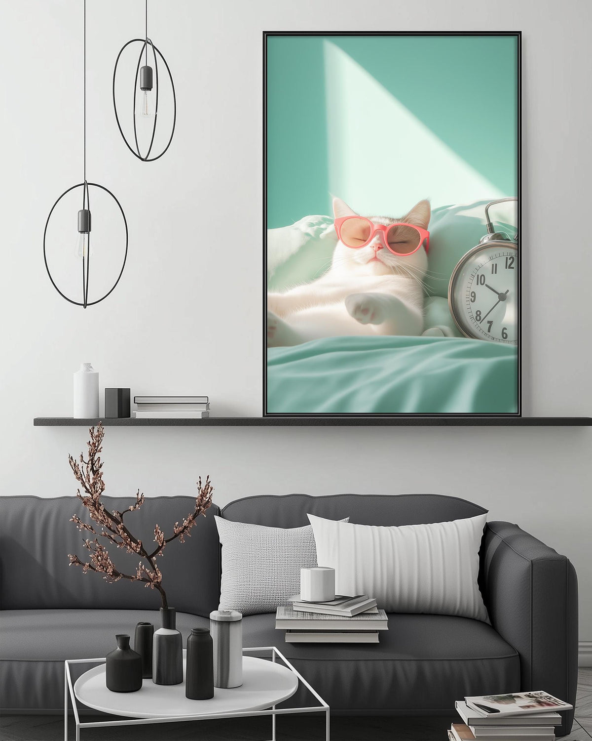 A cozy living room with a gray sofa, a coffee table, and a large framed picture of a cat wearing sunglasses. The picture is hanging on the wall above the sofa.