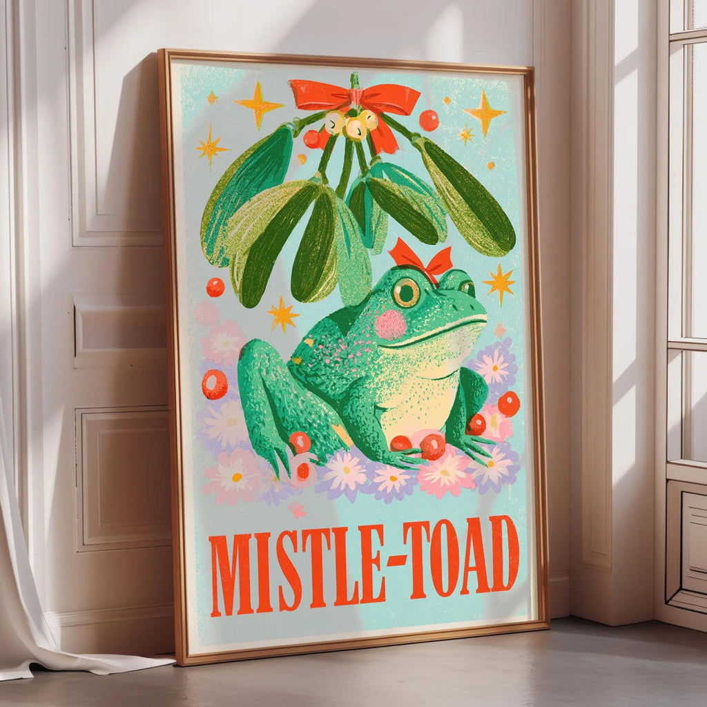 a poster with a green frog sitting under a mistletoe.