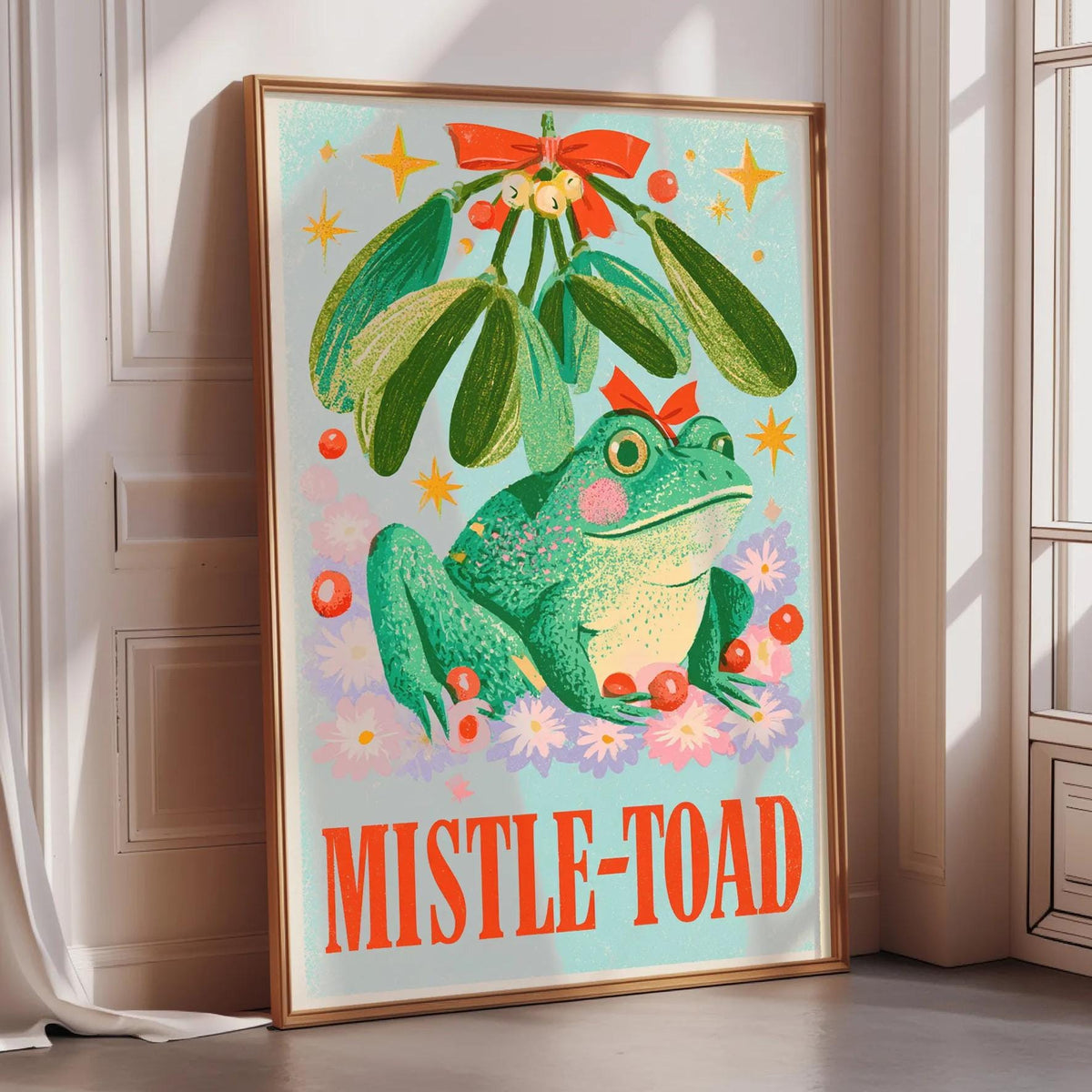 a poster with a green frog sitting under a mistletoe.