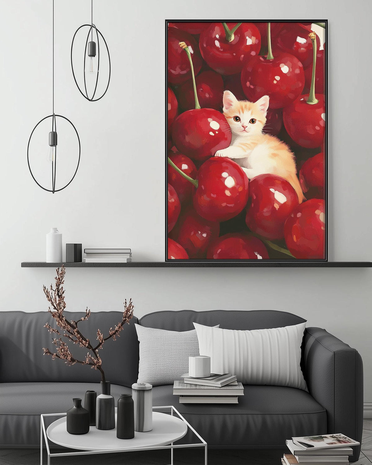 a cozy living room with a gray sofa, a coffee table, and a large framed painting of a kitten sitting among red cherries hanging on the wall above the sofa.