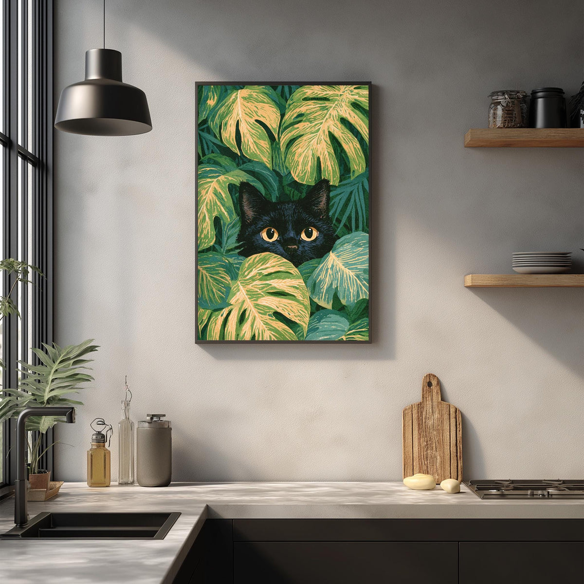 a kitchen counter with a framed painting of a black cat peeking out from behind green leaves, creating a whimsical and playful atmosphere.