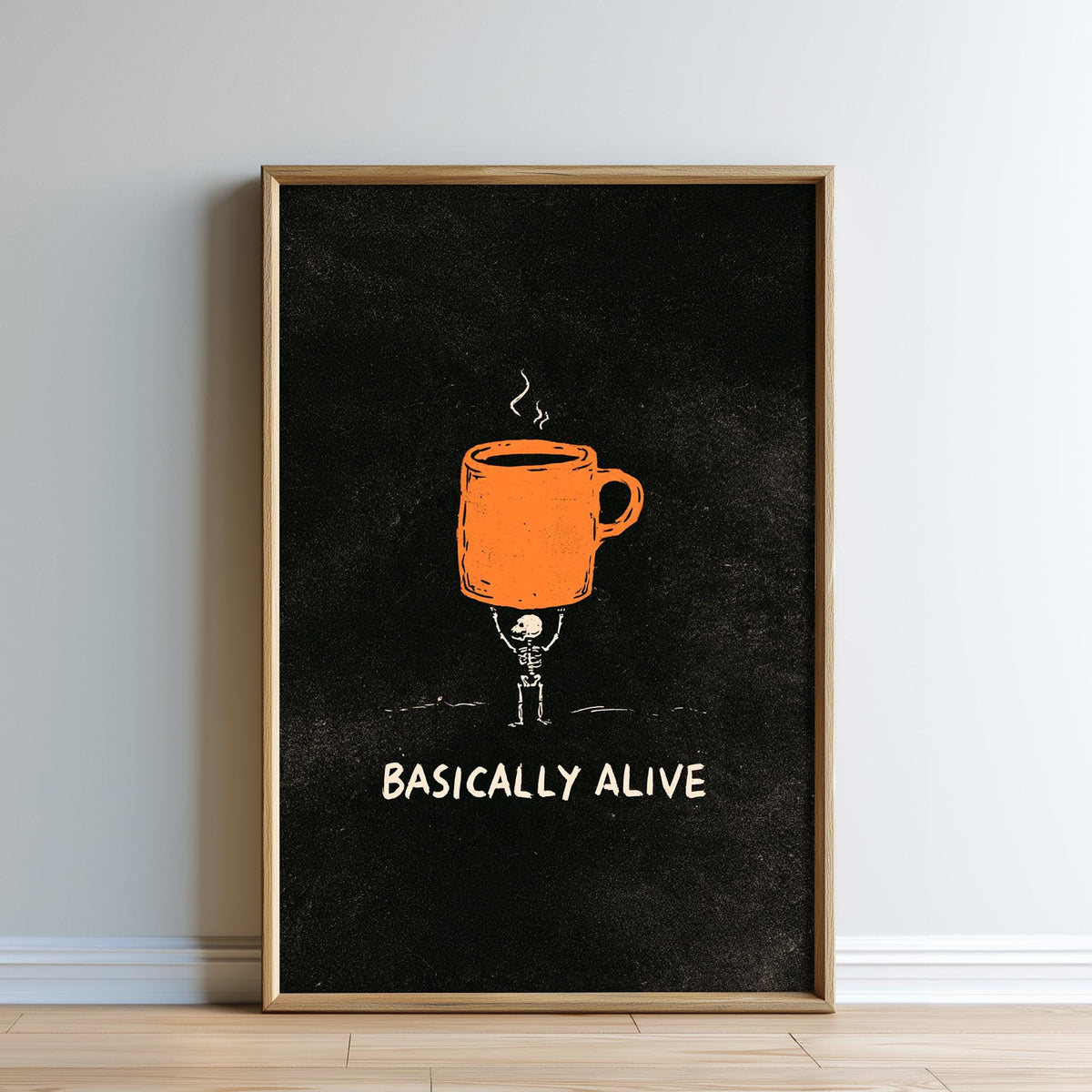 The image is a framed poster with an illustration of a skeleton holding a coffee mug. The poster has the text "BASICALLY ALIVE" written below the illustration.