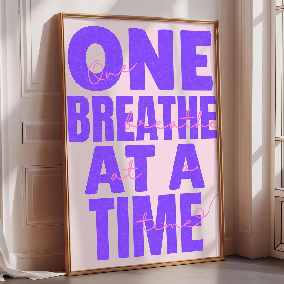 a large poster with the text "ONE BREATHE AT A TIME" in bold purple letters.