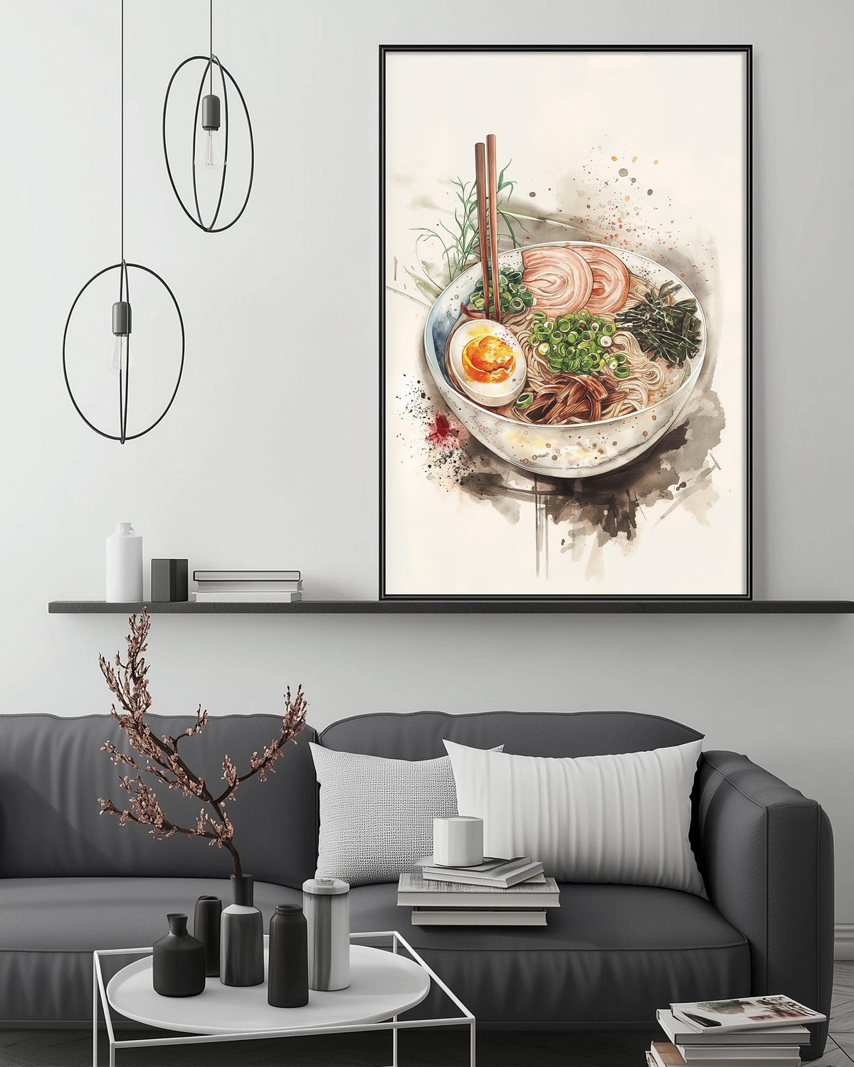 a modern living room with a gray sofa, a coffee table, and a framed print of a bowl of ramen noodles with vegetables hanging on the wall above the sofa.