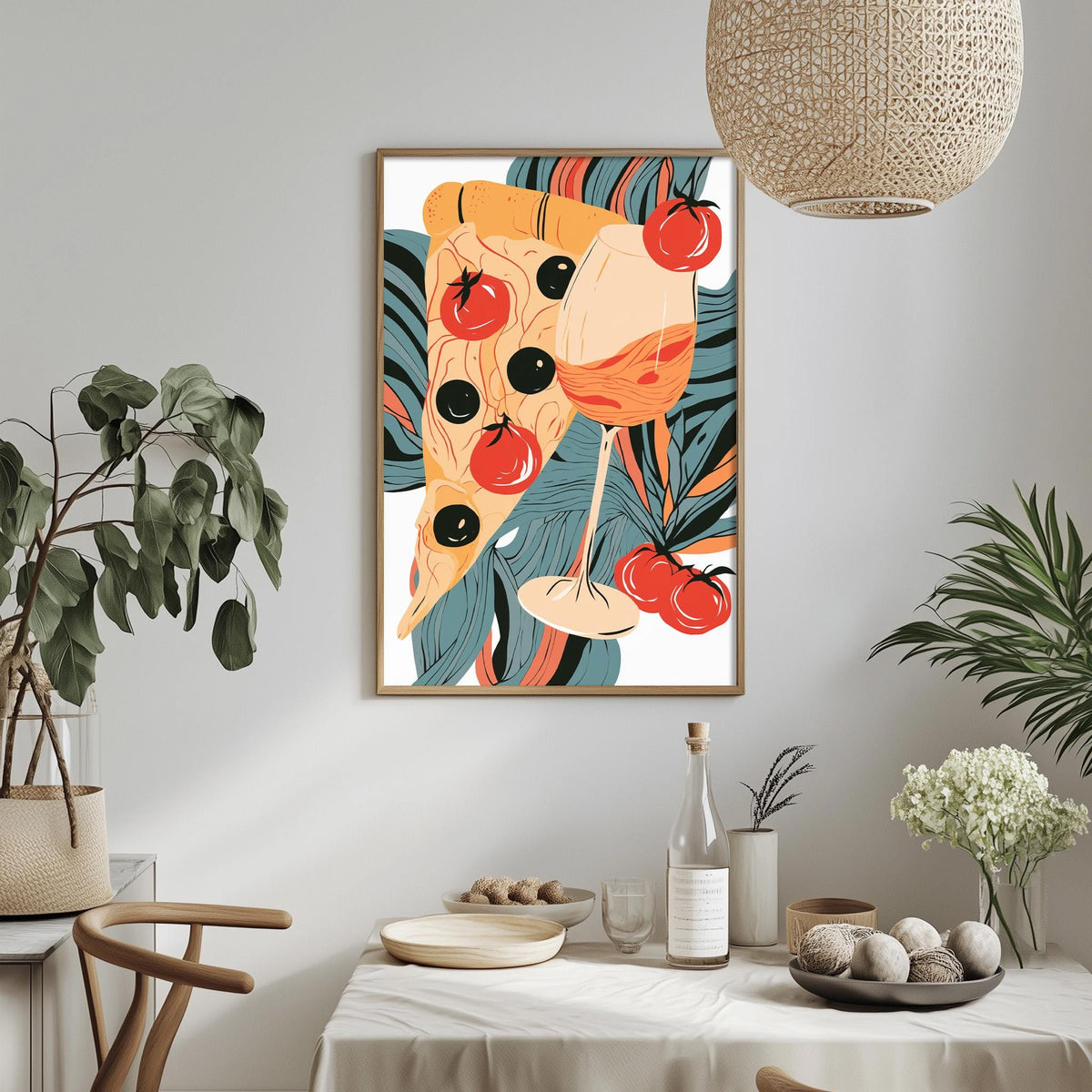 a dining table with a white tablecloth, a bowl of fruit, a bottle, and a vase with flowers. Above the table, there is a framed illustration of a pizza with tomatoes and olives.