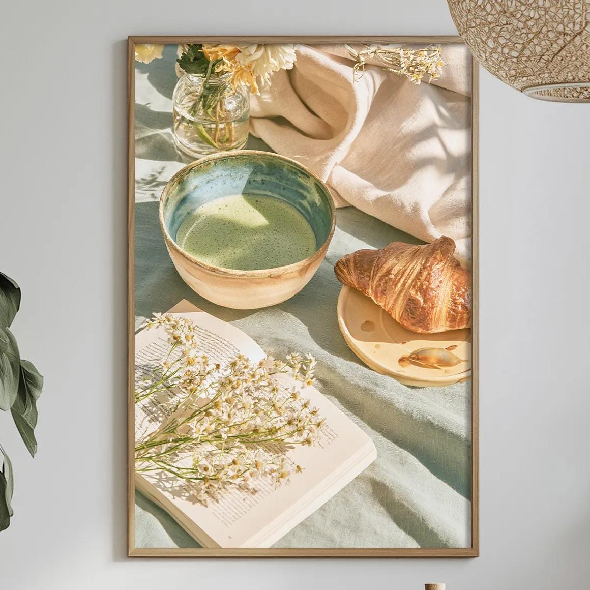 a cozy dining scene with a table set for a meal, featuring a bowl of soup, a croissant, and a vase of flowers. The table is adorned with various items, including a bottle, a bowl, and a plate, creating a warm and inviting atmosphere.