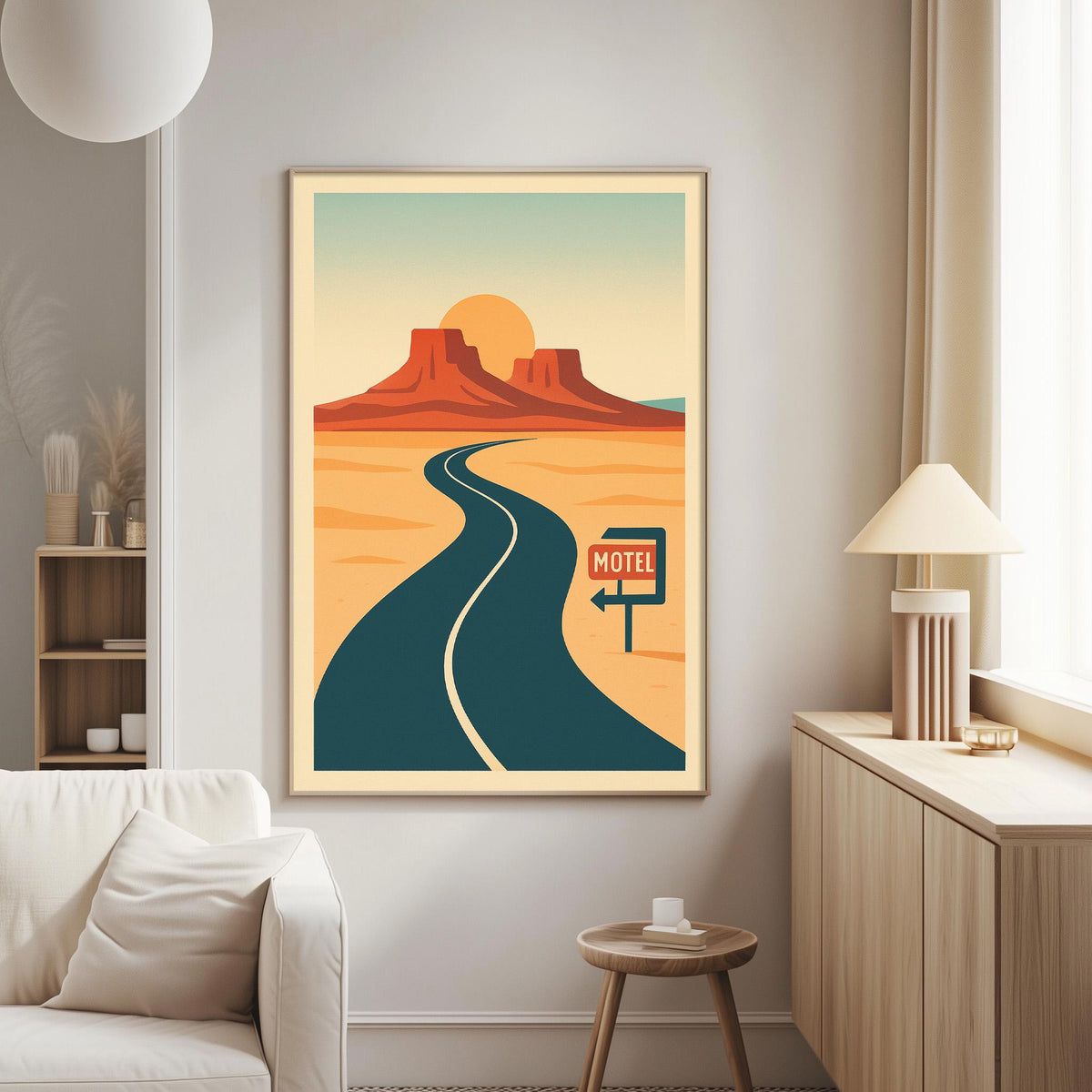 a framed poster of a desert landscape with a winding road leading to a motel sign.